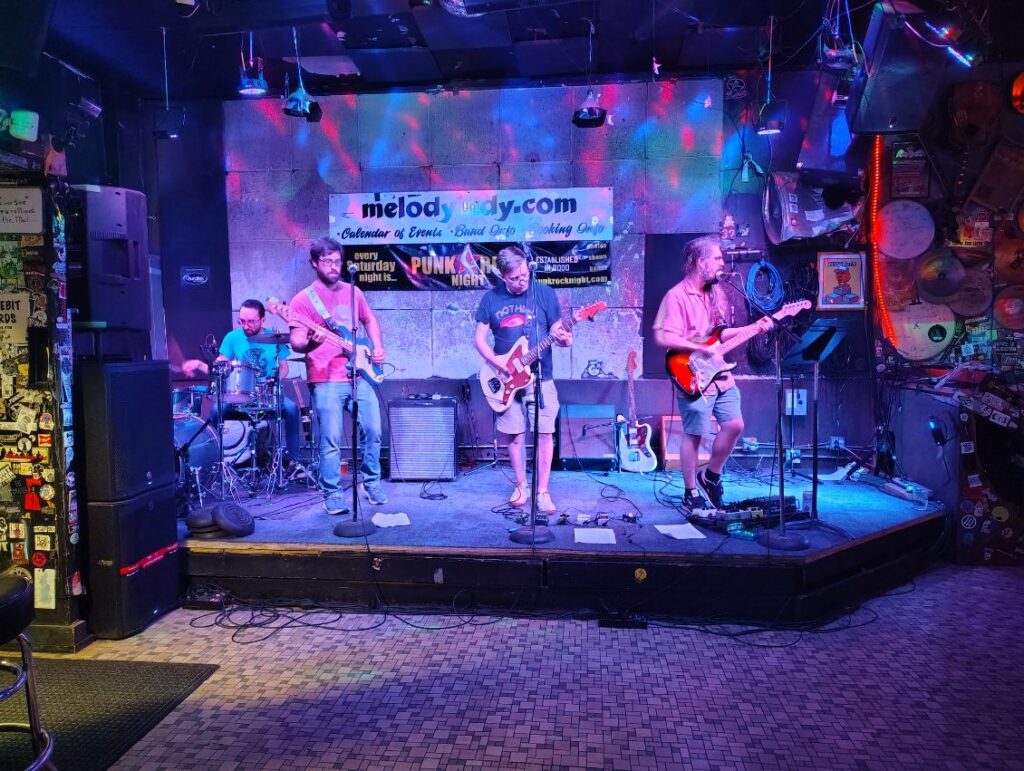 Four musicians play onstage at The Melody Inn.