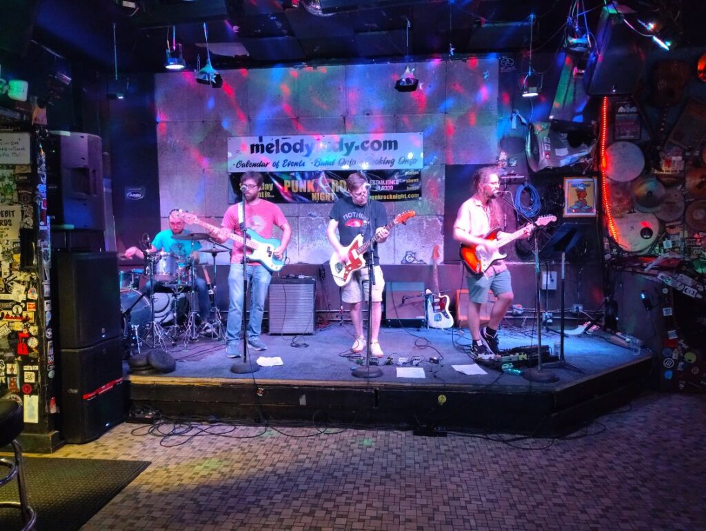 Four musicians play onstage at The Melody Inn.